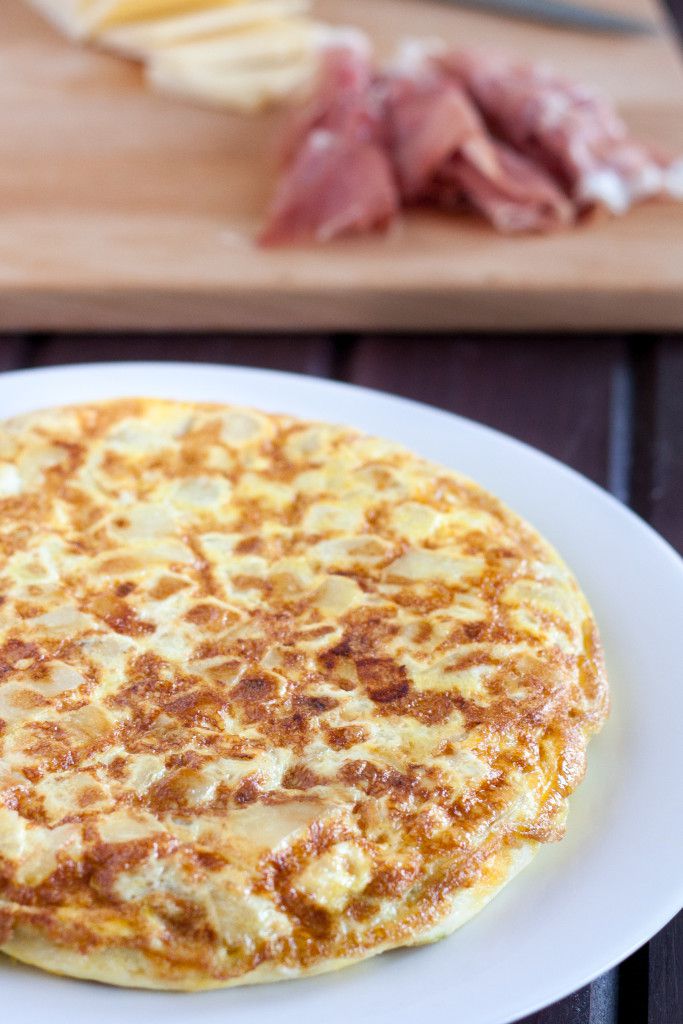 Tortilla Espanola - Spanish Tortilla - is a classic egg and potato dish with infinite variations served all over Spain and in some parts of the Caribbean. An easy budget meal, tortilla can be served any time of day, or cut into cubes and served as a party appetizer! Recipe and variations on GoodieGodmother.com