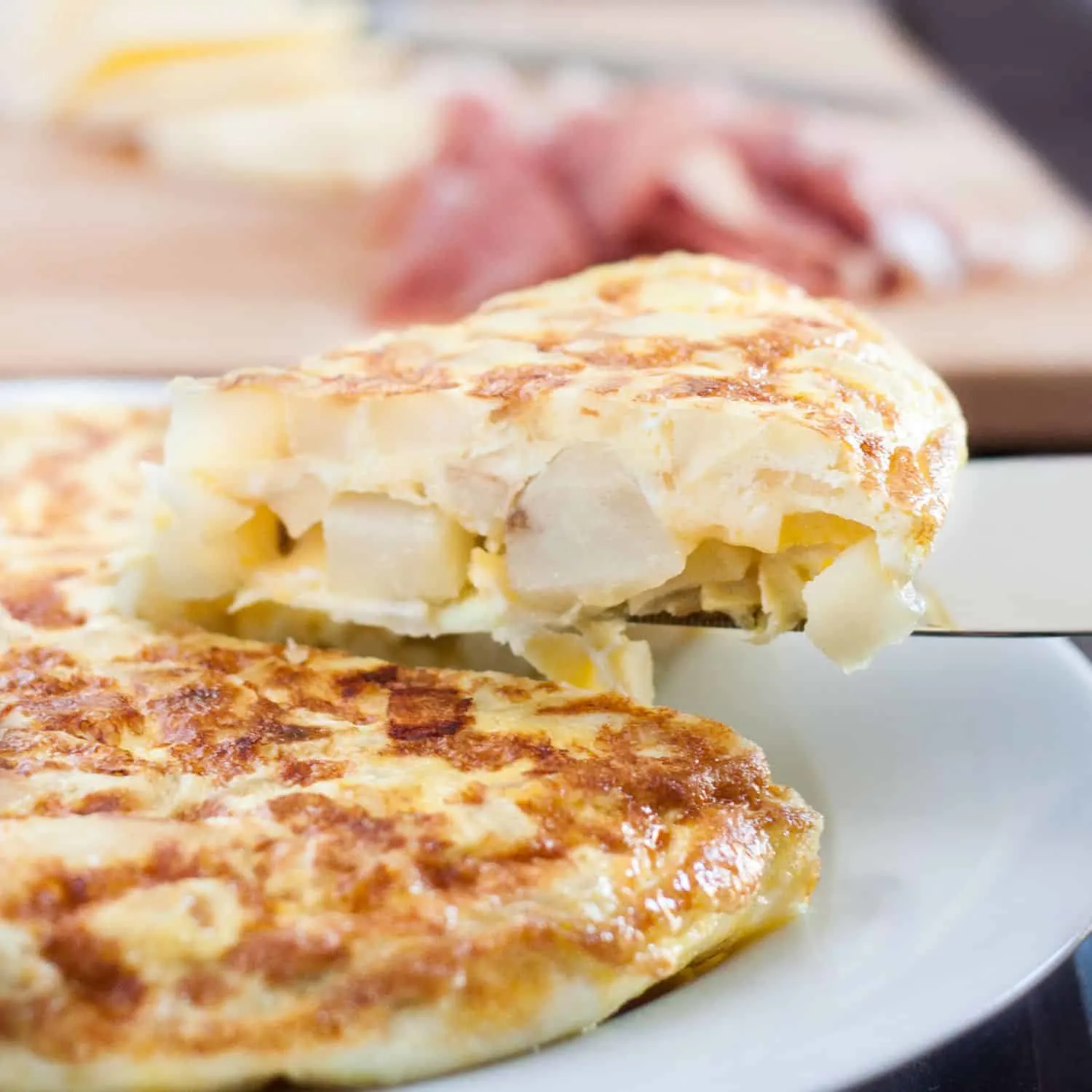 Tortilla Espanola - Spanish Tortilla - is a classic egg and potato dish with infinite variations served all over Spain and in some parts of the Caribbean. An easy budget meal, tortilla can be served any time of day, or cut into cubes and served as a party appetizer! Recipe and variations on GoodieGodmother.com