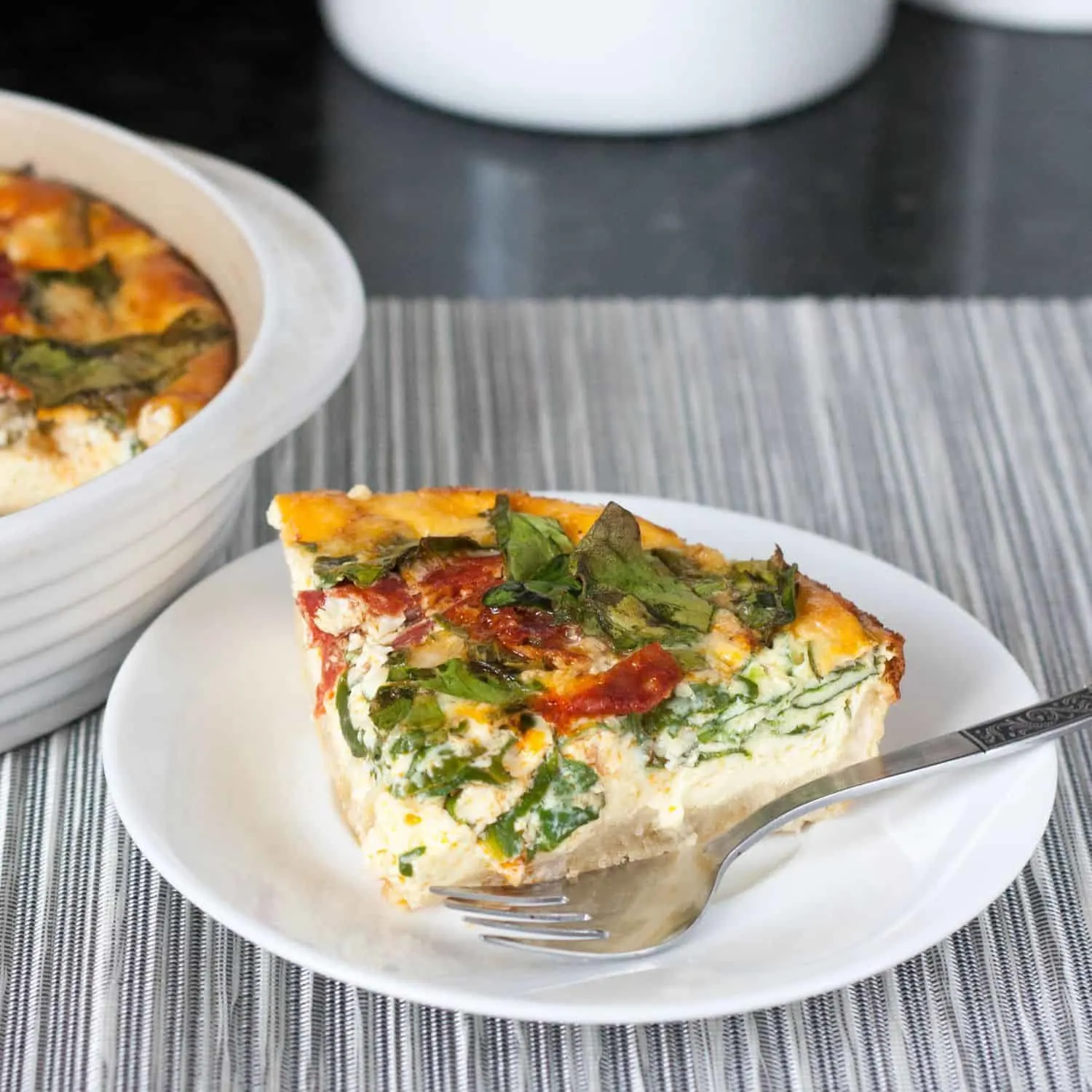 Easy Spanish Chorizo, Manchego, Spinach Quiche with an olive oil crust. With only minutes of active prep time, you can create an impressive dish perfect for a light meal. Get the recipe on GoodieGodmother.com