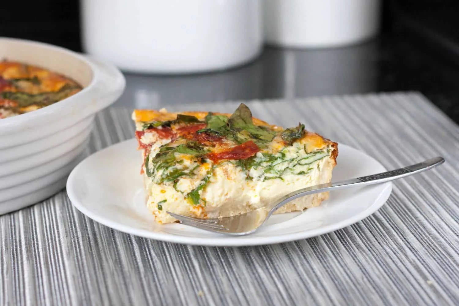 Easy Spanish Chorizo, Manchego, Spinach Quiche with an olive oil crust. With only minutes of active prep time, you can create an impressive dish perfect for a light meal. Get the recipe on GoodieGodmother.com 