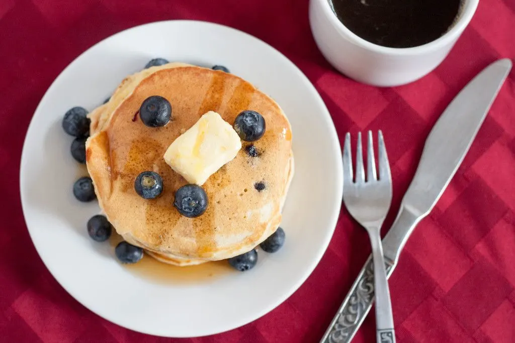 Make fluffy blueberry pancakes a little healthier by adding golden flax. Kid and husband approved! Recipe on GoodieGodmother.com