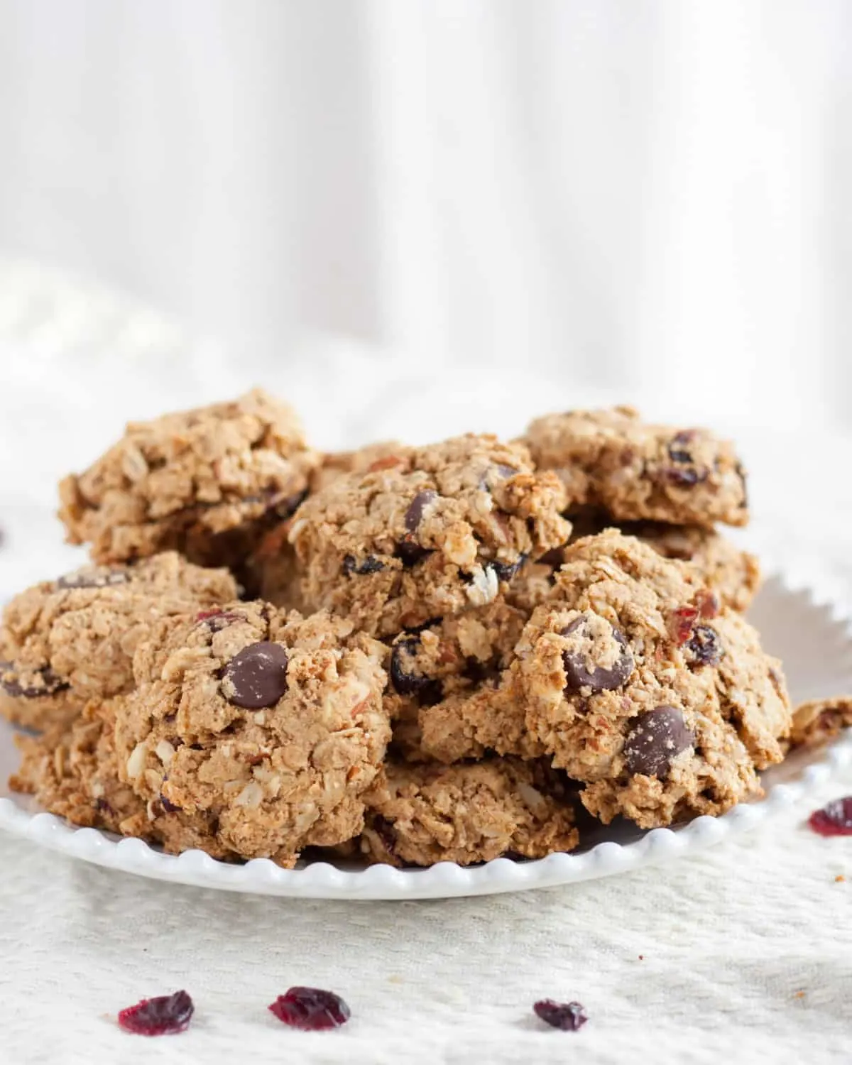 Loaded with oats, nuts, dried cranberries, and dark chocolate, these make-ahead breakfast cookies are freezer-friendly & pair perfectly with a latte or milk. Recipe on GoodieGodmother.com