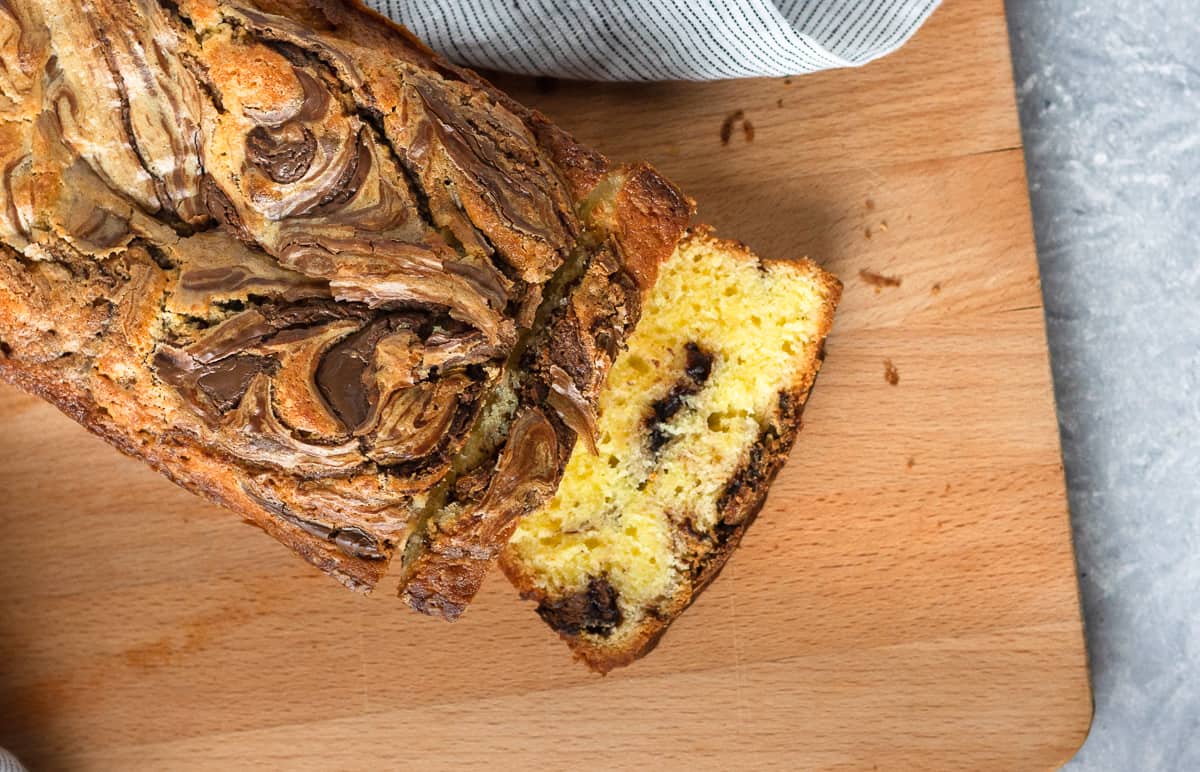 Rich and moist, with a delicious hazelnut chocolate ribbon, Nutella swirl pound cake is a perfectly decadent quick bread recipe. This Nutella bread recipe makes a great snack or edible gift idea. Recipe on GoodieGodmother.com