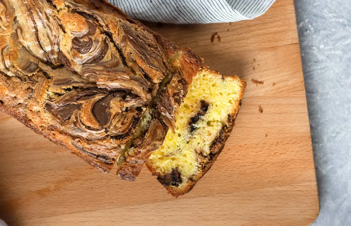 Rich and moist, with a delicious hazelnut chocolate ribbon, Nutella swirl pound cake is a perfectly decadent quick bread recipe. This Nutella bread recipe makes a great snack or edible gift idea. Recipe on GoodieGodmother.com