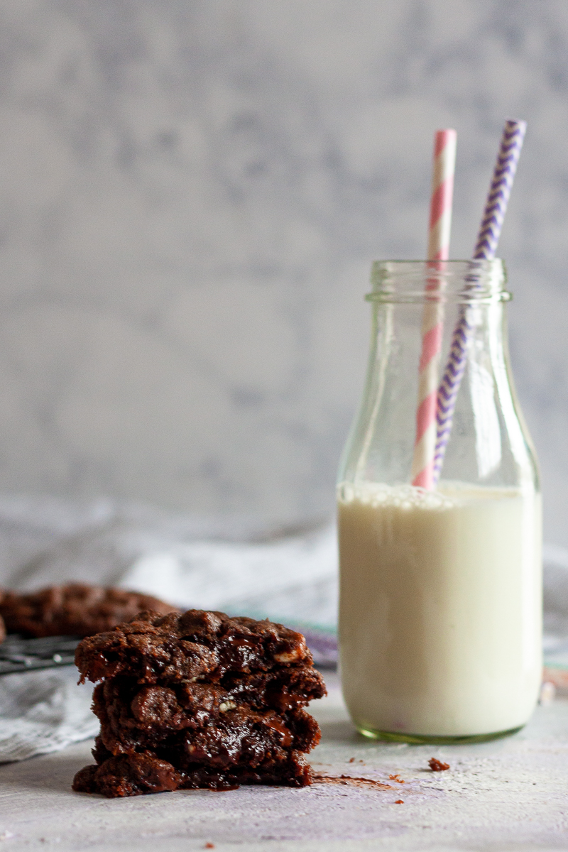 double chocolate chip cookies next to a glass of milk