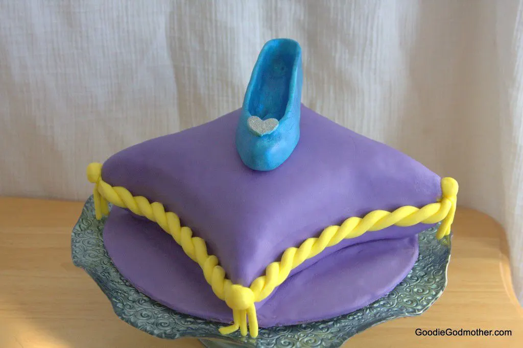 How to make a Cinderella shoe cake topper out of fondant. Blog post contains a video tutorial and helpful tips and tricks! 