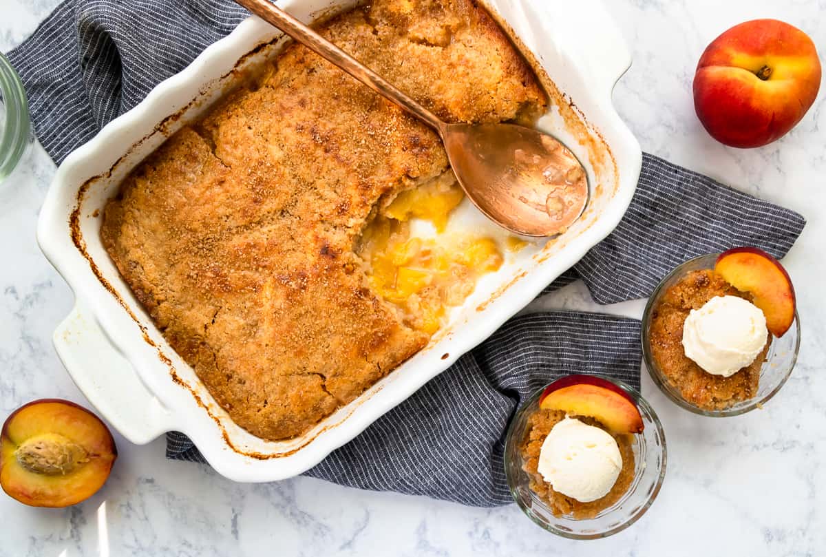 Fresh peach cobbler is a hallmark summertime recipe! You can make peach cobbler year round, but there's something extra special about a summer fruit cobbler with fresh peaches. Peach cobbler is a great easy recipe for summer entertaining.  * GoodieGodmother.com