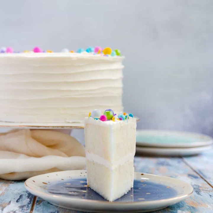 Naturally white, and easy to mix up with no special ingredients required, this white cake recipe from scratch is moist and delicious! Put down the box mix, and make white cake from scratch at home. * Recipe on GoodieGodmother.com #whitecake #weddingcake #birthdaycake #vanillacake