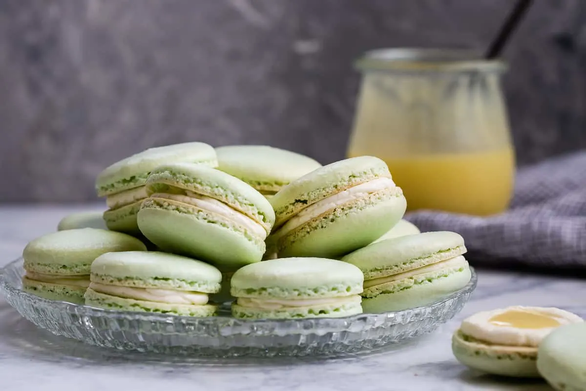 Key lime macarons are filled with a key lime buttercream and key lime curd. Lots of key lime flavor packed into every naturally gluten-free macaron bite! * Recipe on GoodieGodmother.com