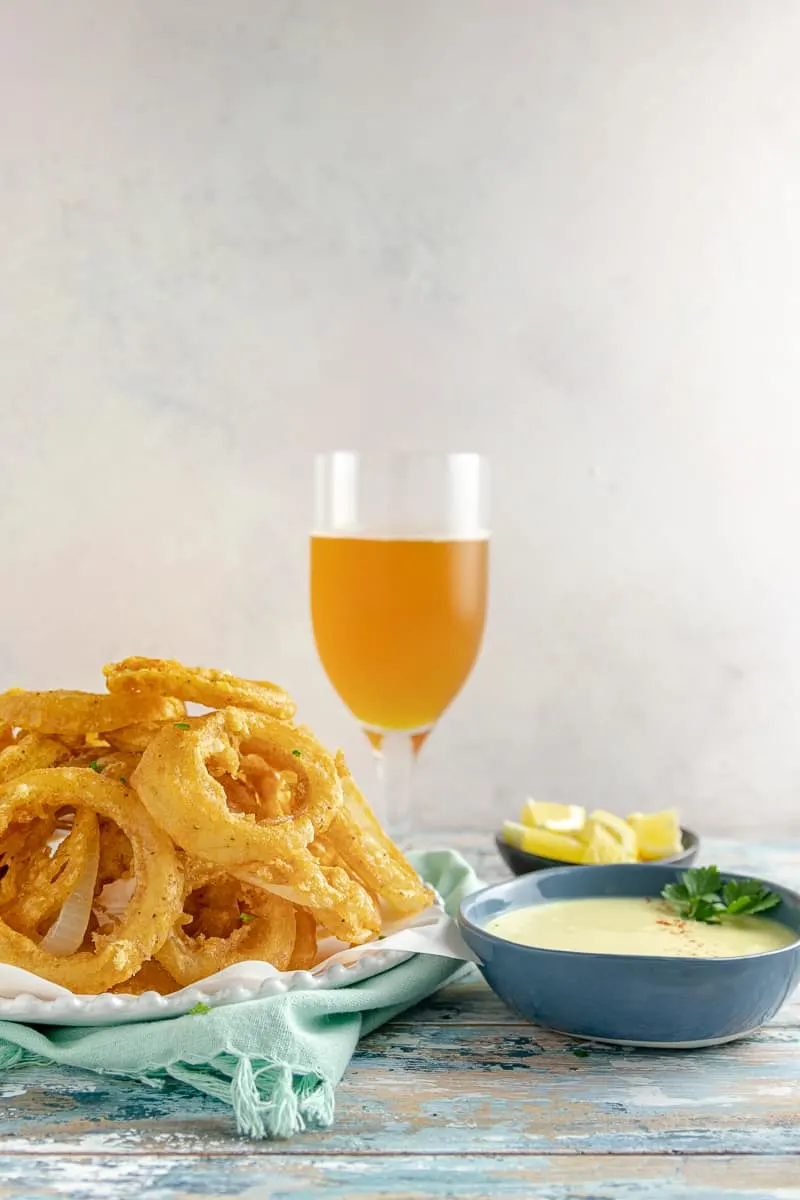 Beer Battered Old Bay Onion Rings with Creamy Lemon Dipping Sauce - An appetizer or side dish that's boardwalk ready, no matter where you are!