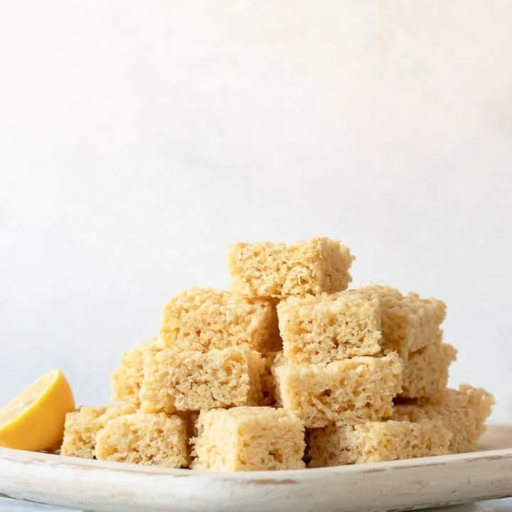 lemon crispy rice treats piled high on a square serving platter
