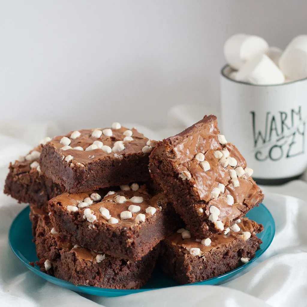 To die for caramel hot chocolate brownies! A fudgy, creative dessert using hot chocolate mix. Drizzle with extra caramel after baking for a super decadent treat.