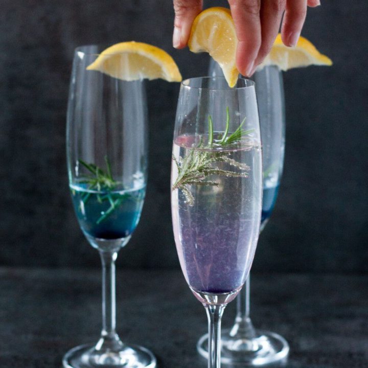 A refreshing New Year's Eve Cocktail! Get the color changing Rosemary 75 champagne cocktail recipe on GoodieGodmother.com