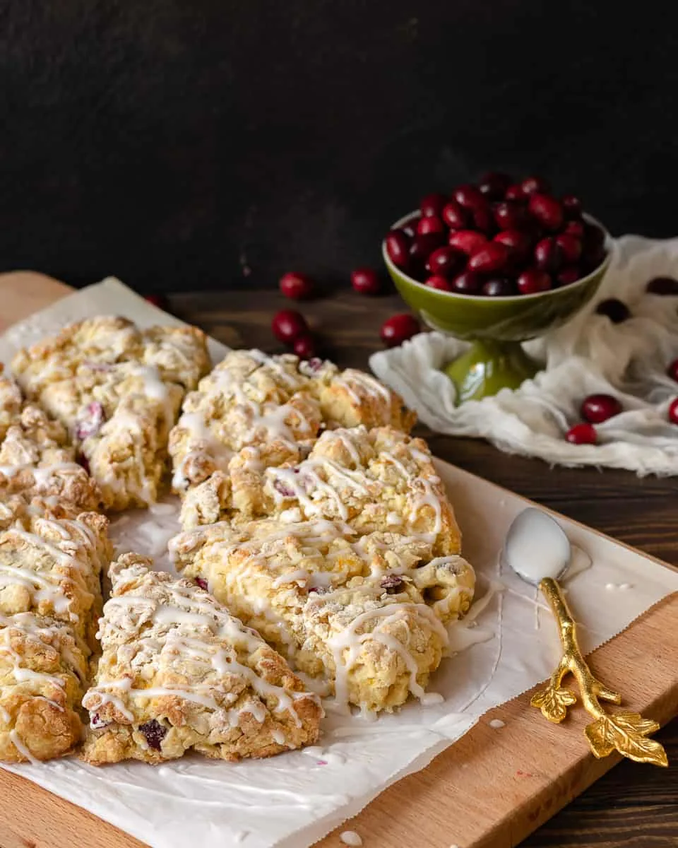 Keep winter breakfast bright with these flavorful fresh cranberry orange scones! Make the dough ahead and freeze, or mix and bake in under an hour. This easy buttermilk scone recipe is a great way to use fresh cranberries! * Recipe on GoodieGodmother.com