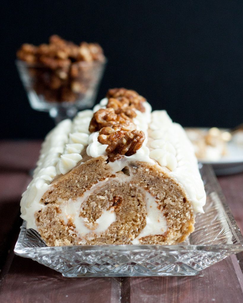 A new way to eat banana bread! Traditional banana bread turned into a roll cake, filled with cream cheese frosting, and topped with balsamic glazed walnuts. Recipe on GoodieGodmother.com