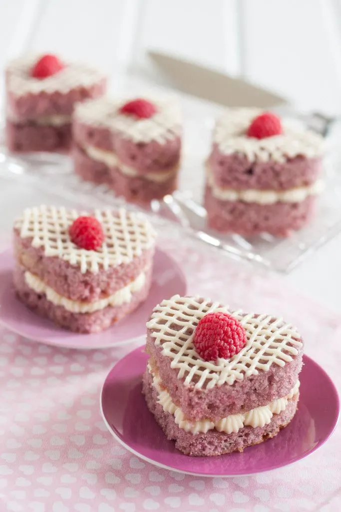 Fresh Raspberry Mini Cakes - A perfect Valentine's Day dessert without chocolate! These are so easy to make, even for a novice baker. They're the perfect size for eating alone, sharing with someone you love, or they package beautifully for a thoughtful gift. Recipe on GoodieGodmother.com