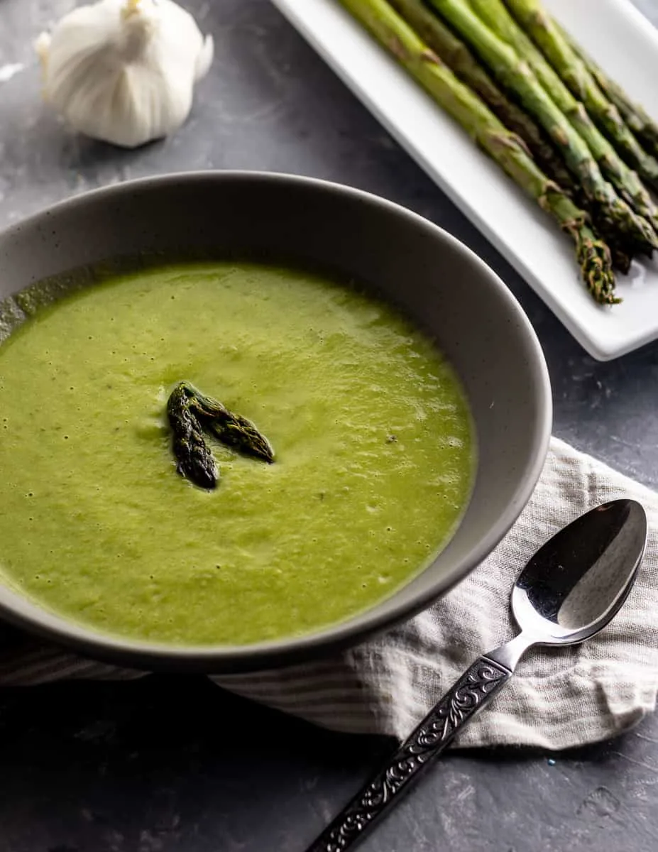 Welcome the coming of warmer days, even on cooler evenings, with this delicious Asparagus Garlic Soup. It's one of my favorite easy asparagus recipes to enjoy during asparagus season!