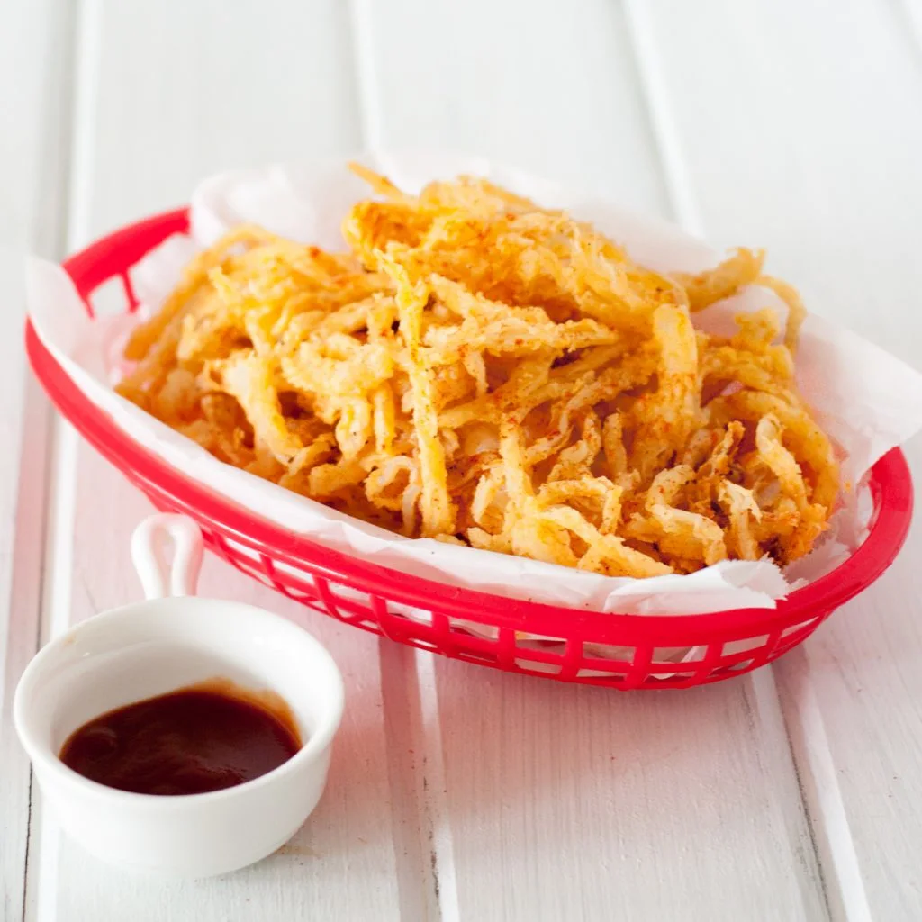 Crispy smoked paprika onion straws are an easy and delicious addition to burgers, salads, steaks, sandwiches, or a fun snack to enjoy just because. Recipe found on GoodieGodmother.com