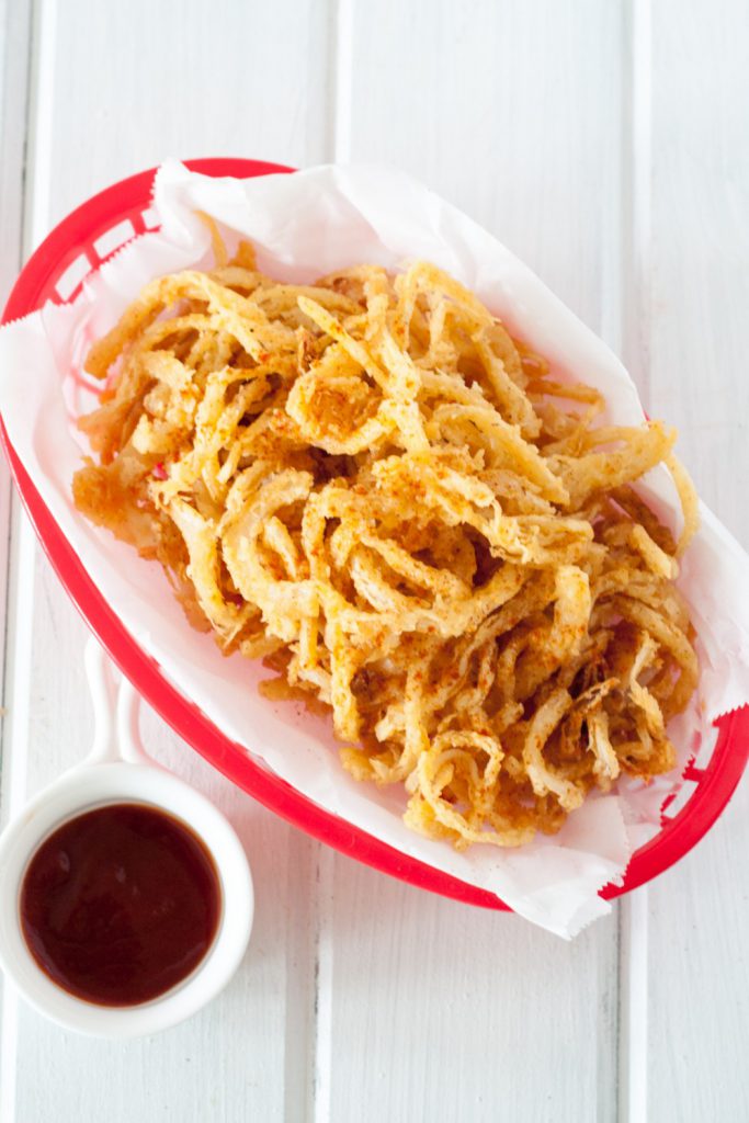 Crispy smoked paprika onion straws are an easy and delicious addition to burgers, salads, steaks, sandwiches, or a fun snack to enjoy just because. Recipe found on GoodieGodmother.com