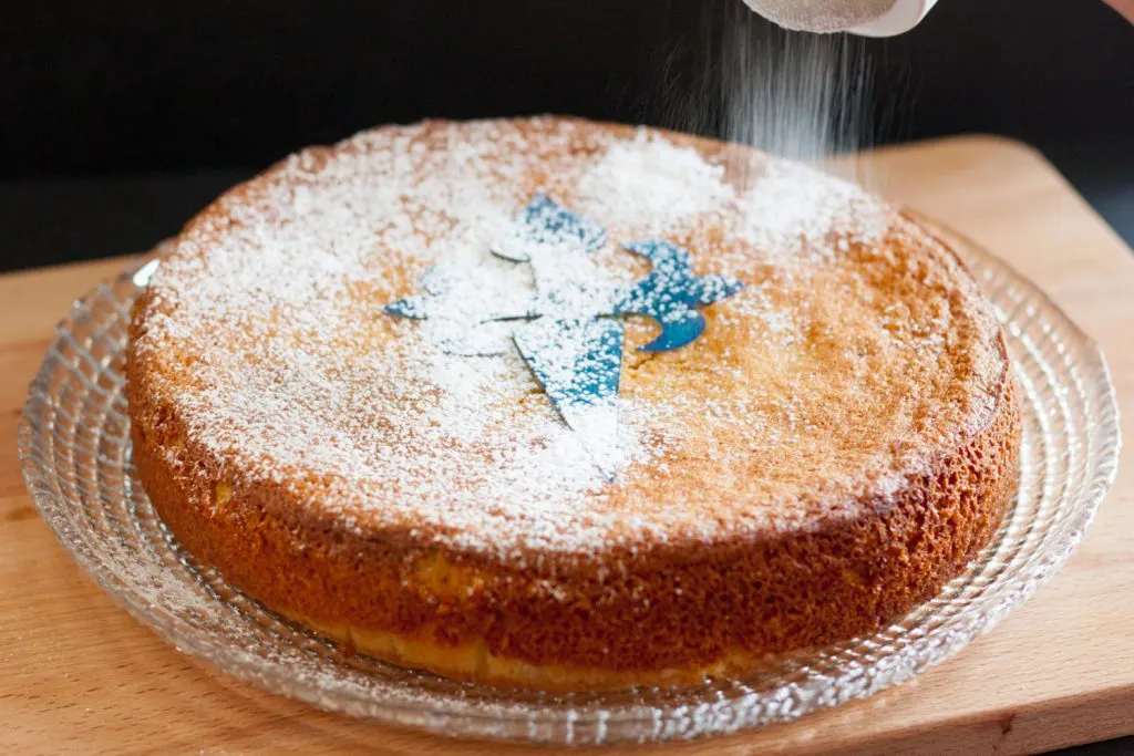 The Tarta de Santiago (Saint James Cake) is a classic Spanish dessert. This gluten free almond cake recipe is simple to follow and makes a delightful dessert or tea cake. * GoodieGodmother.com