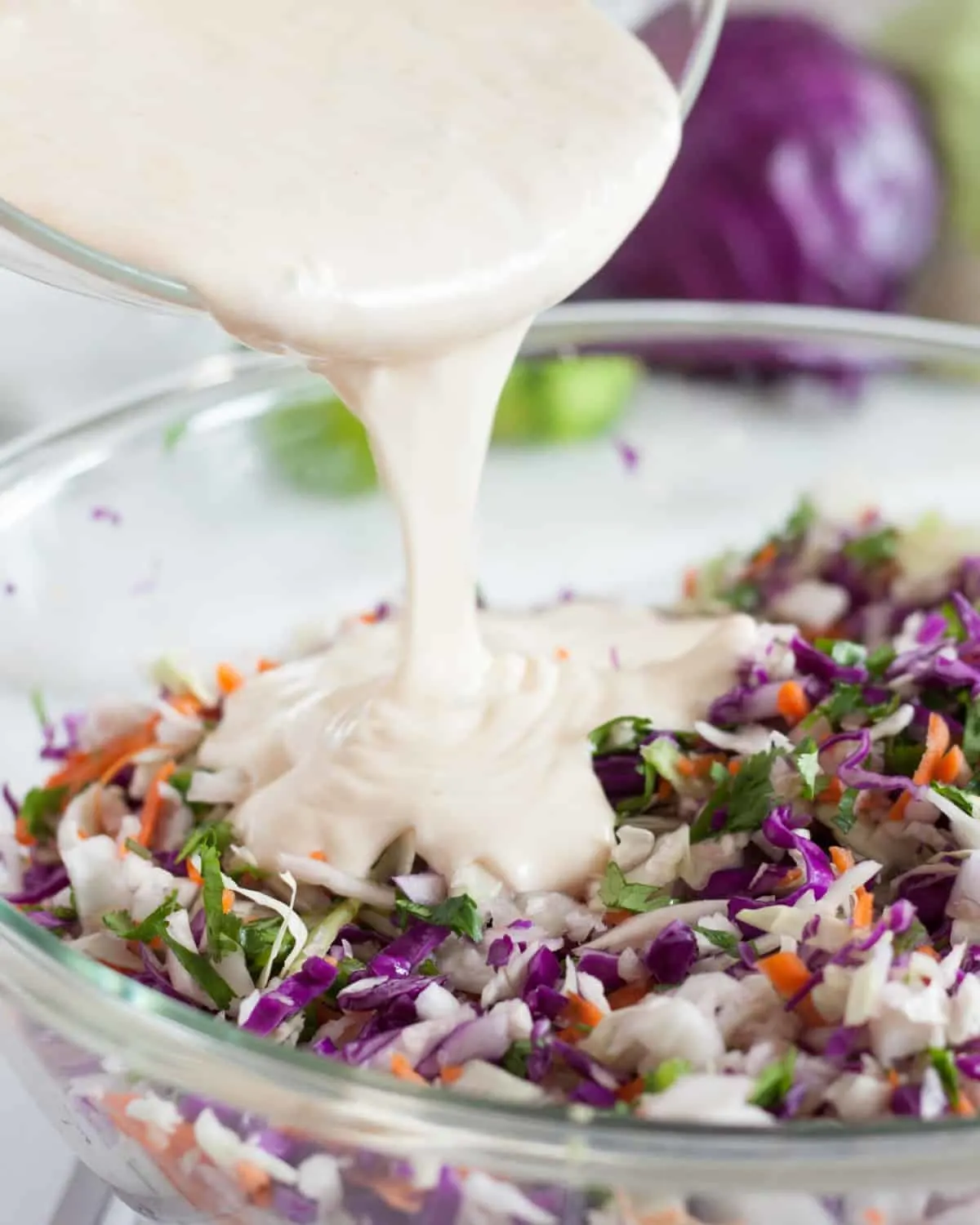 Creamy crunchy cilantro lime coleslaw makes a perfect side dish for tacos, a BBQ, or as a salad. This coleslaw recipe is a deliciously light and refreshing twist. The simple healthy The combination of cabbage, red cabbage, carros, cilantro, with your choice of mayo, sour cream, or greek yogurt make a creamy coleslaw that you will want to make over and over again. #coleslaw #sidedish #cabbage #recipe #healthy #creamy