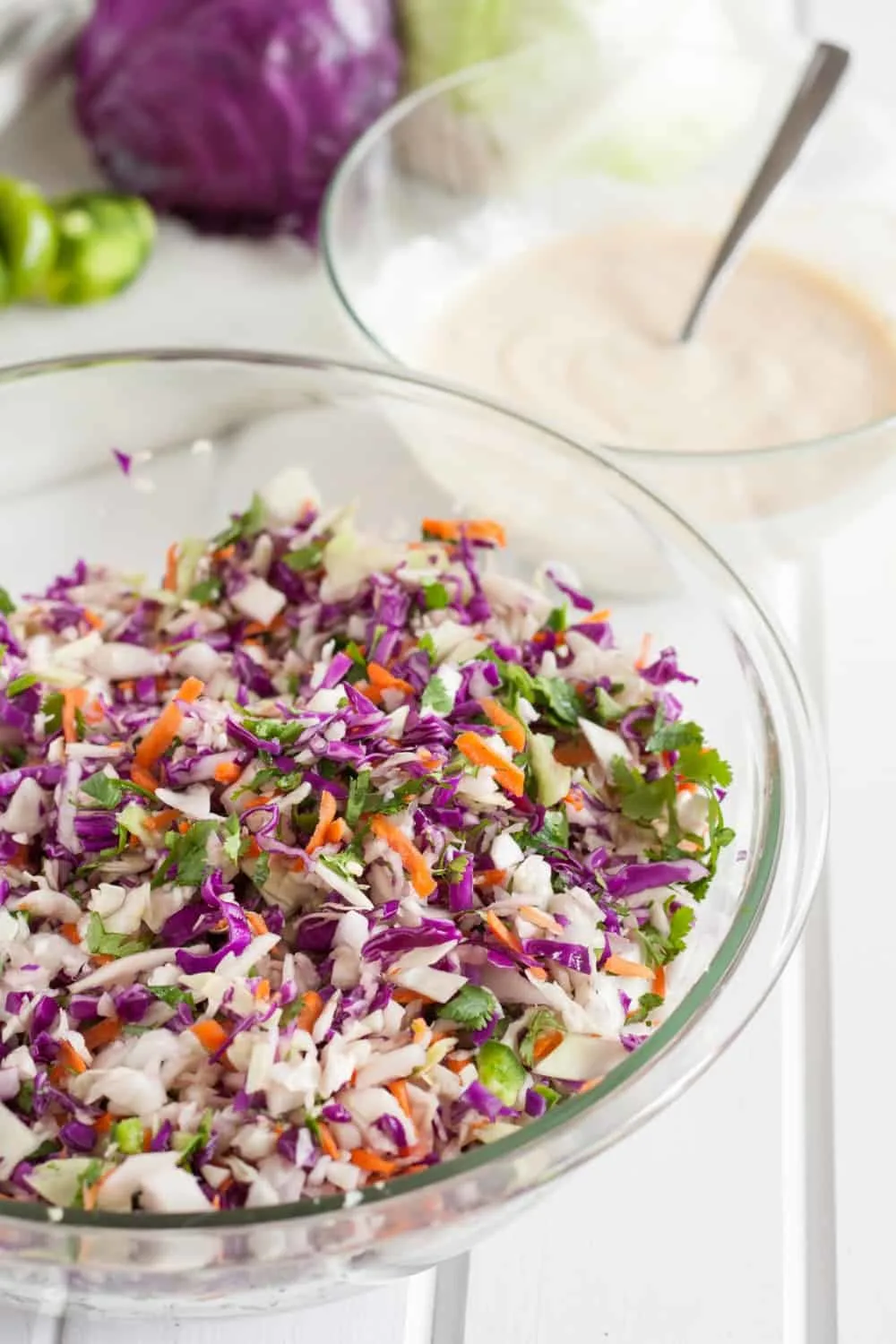 Creamy crunchy cilantro lime coleslaw makes a perfect side dish for tacos, a BBQ, or as a salad. This coleslaw recipe is a deliciously light and refreshing twist. The simple healthy The combination of cabbage, red cabbage, carros, cilantro, with your choice of mayo, sour cream, or greek yogurt make a creamy coleslaw that you will want to make over and over again. #coleslaw #sidedish #cabbage #recipe #healthy #creamy