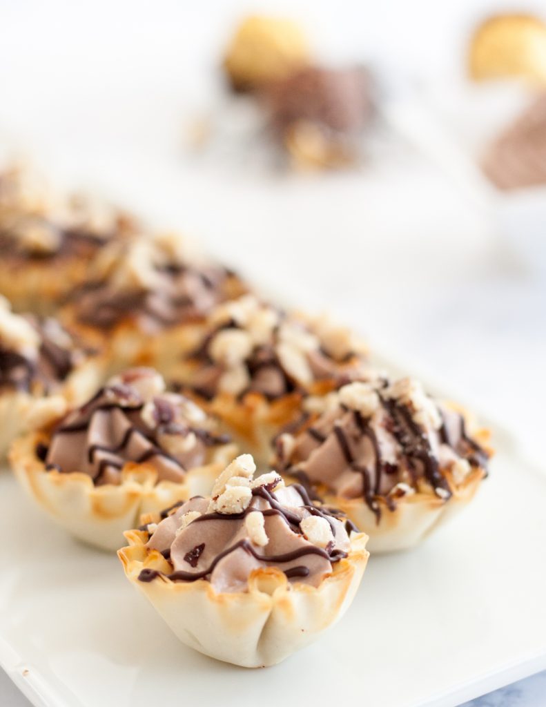 Easy Ferrero Rocher Cannoli Cups - This easy bite size dessert comes together in just a few minutes and is always a hit at parties! * Recipe on GoodieGodmother.com