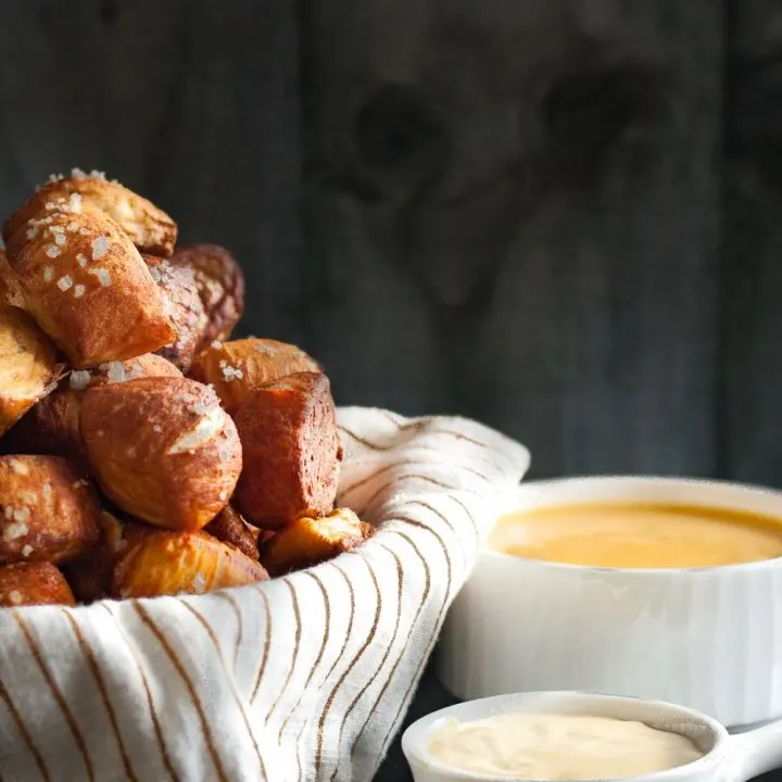 Pretzel bites are the perfect snack food! Easier to make than you'd think, you'll definitely want to add these pretzel bites with green chili cheddar and mustard dipping sauces to your next party menu. * Recipe on GoodieGodmother.com
