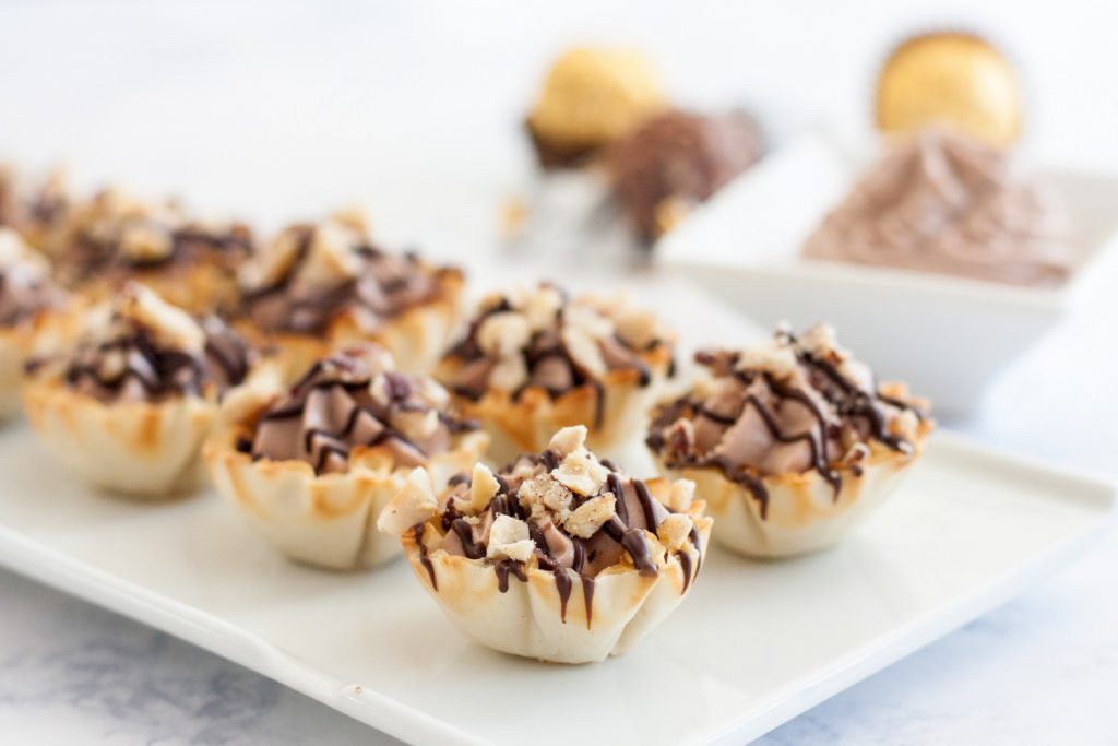 Easy Ferrero Rocher Cannoli Cups - This easy bite size dessert comes together in just a few minutes and is always a hit at parties! * Recipe on GoodieGodmother.com