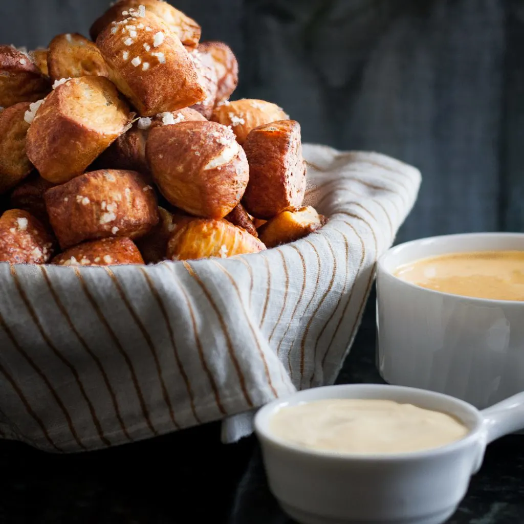Pretzel bites are the perfect snack food! Easier to make than you'd think, you'll definitely want to add these pretzel bites with green chili cheddar and mustard dipping sauces to your next party menu. * Recipe on GoodieGodmother.com