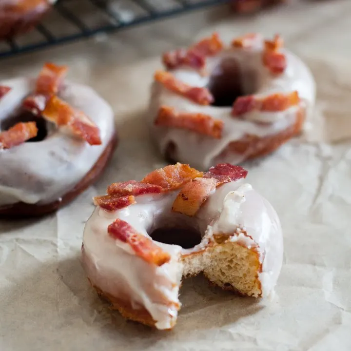 Sweet and salty are a wonderful combination and make these maple bacon doughnuts a treat that won't last long! Recipe on GoodieGodmother.com