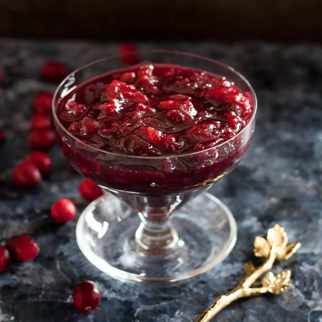 Fresh cranberries and in-season pomegranates make a perfect pairing in this easy slow cooker pomegranate cranberry sauce recipe! * Recipe on GoodieGodmother.com
