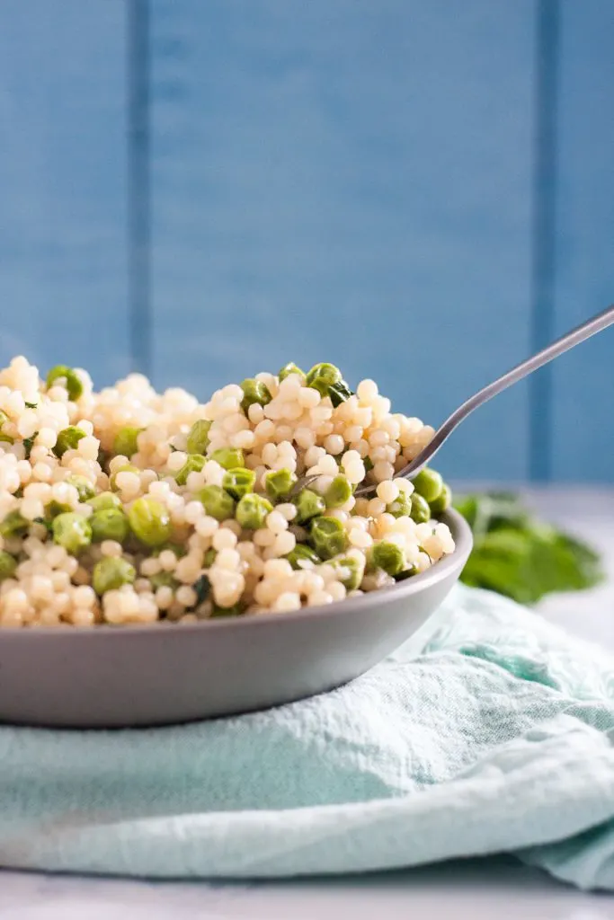 Mint Pea Couscous salad is a great light side dish for roasts like lamb or ham. * Recipe on GoodieGodmother.com