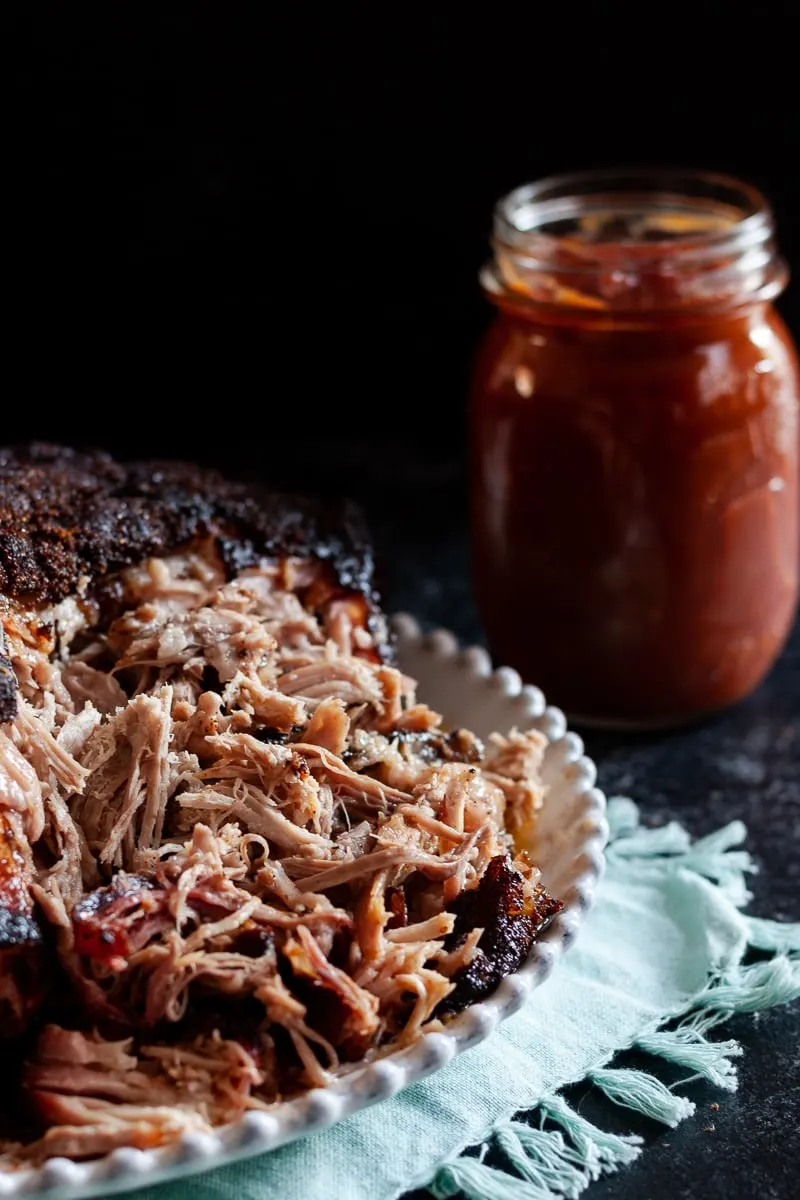Memphis style pork shoulder is a must make barbecue recipe! It's so flavorful, especially when paired with the homemade bbq sauce, and leftovers are super versatile. * GoodieGodmother.com #recipe #porkshoulder #bbq #barbecue #smokerrecipe