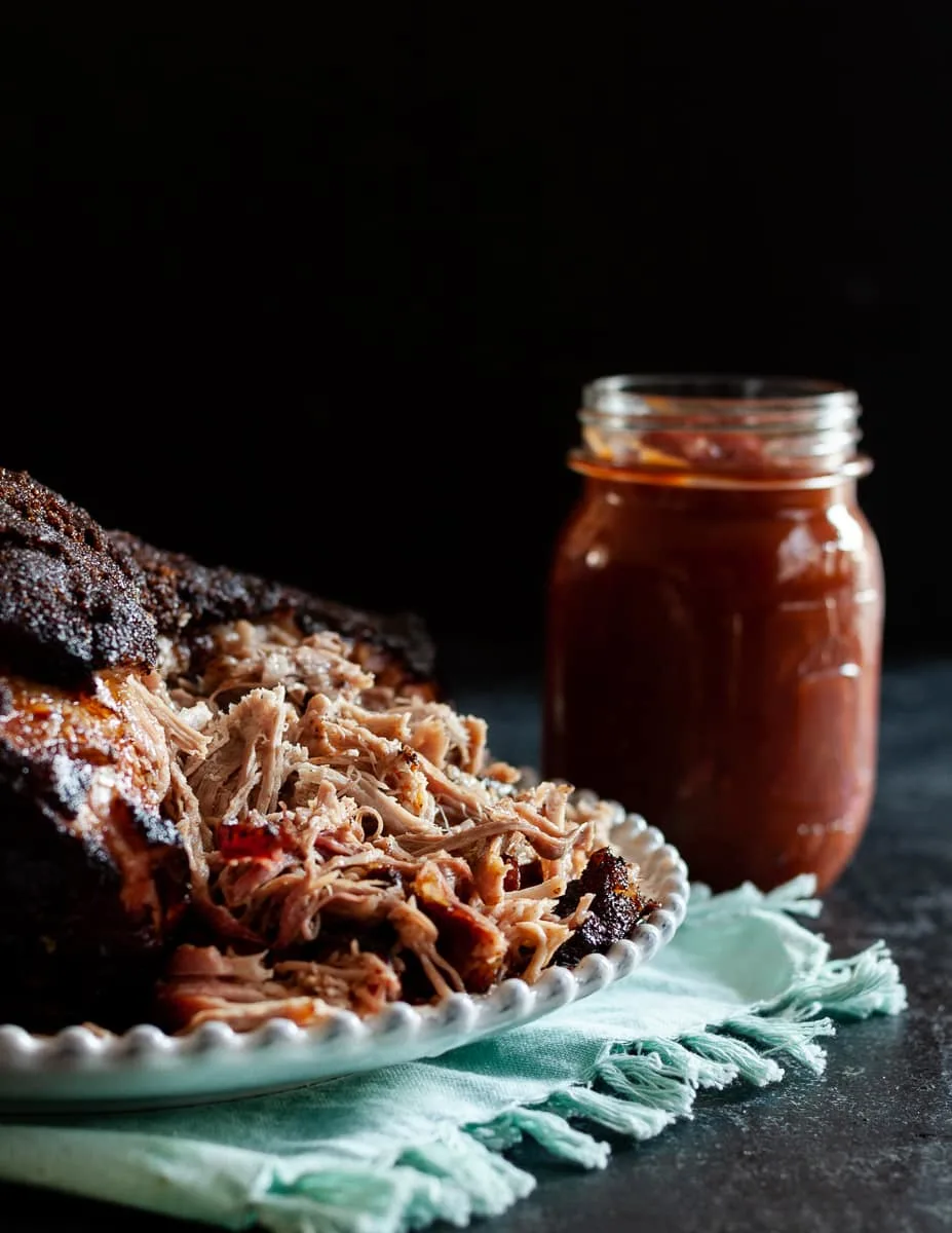 Memphis style pork shoulder is a must make barbecue recipe! It's so flavorful, especially when paired with the homemade bbq sauce, and leftovers are super versatile. * GoodieGodmother.com #recipe #porkshoulder #bbq #barbecue #smokerrecipe