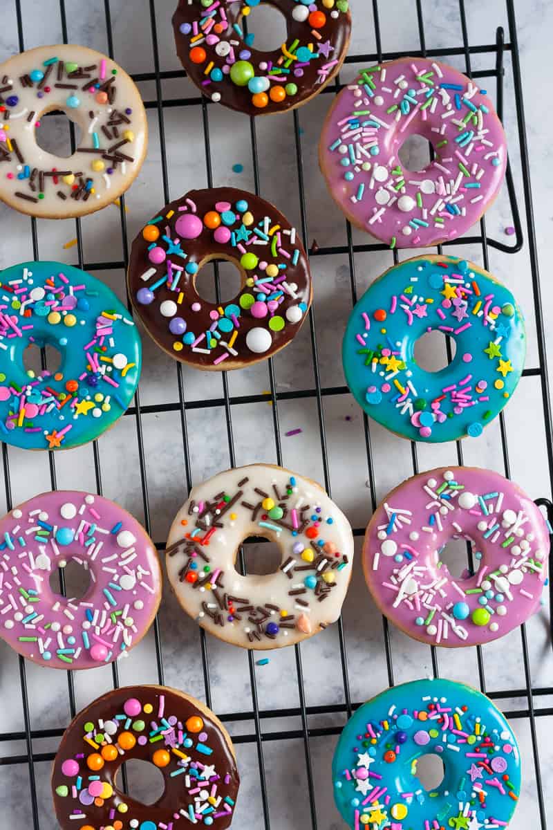Whip up a batch of colorful iced sugar cookies in no time with this doughnut sugar cookie tutorial and easy cookie glaze recipe! It's so easy to make these colorful cookies - even if you've never decorated a sugar cookie before. * GoodieGodmother.com
