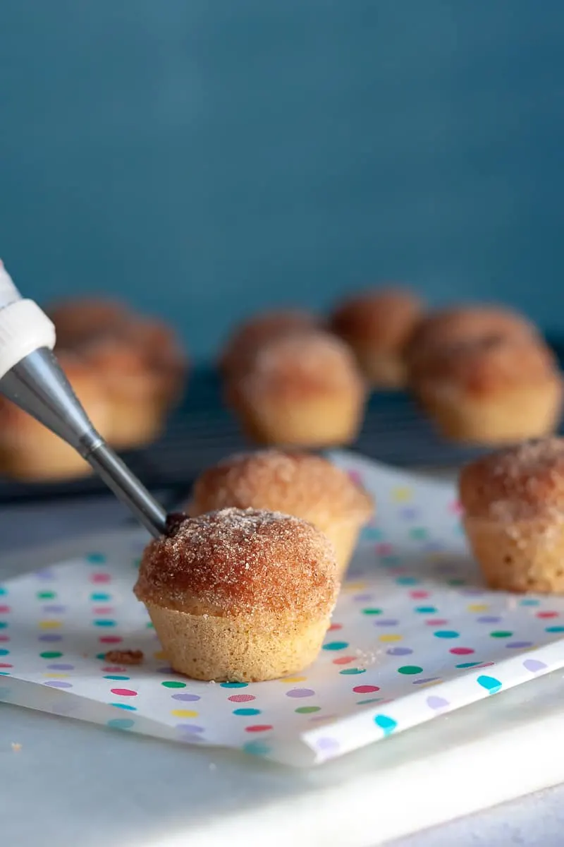 Satisfy your breakfast sweet tooth with these easy Nutella Stuffed Mini Donut Muffins!﻿ * Recipe on GoodieGodmother.com