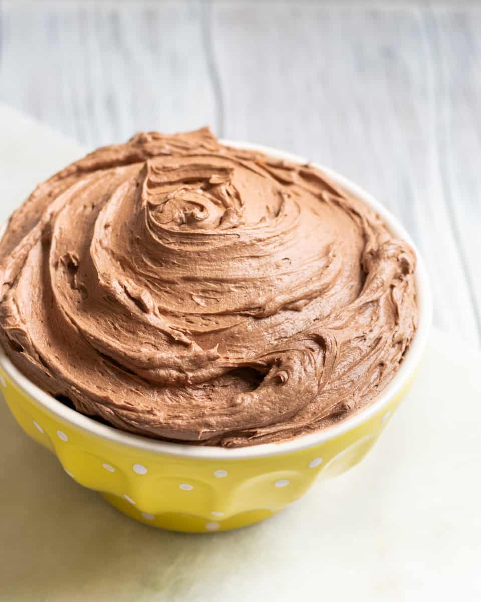 A rich and creamy all butter chocolate American buttercream frosting recipe. This decadent chocolate buttercream frosting gets 2 beaters up! * Recipe on GoodieGodmother.com