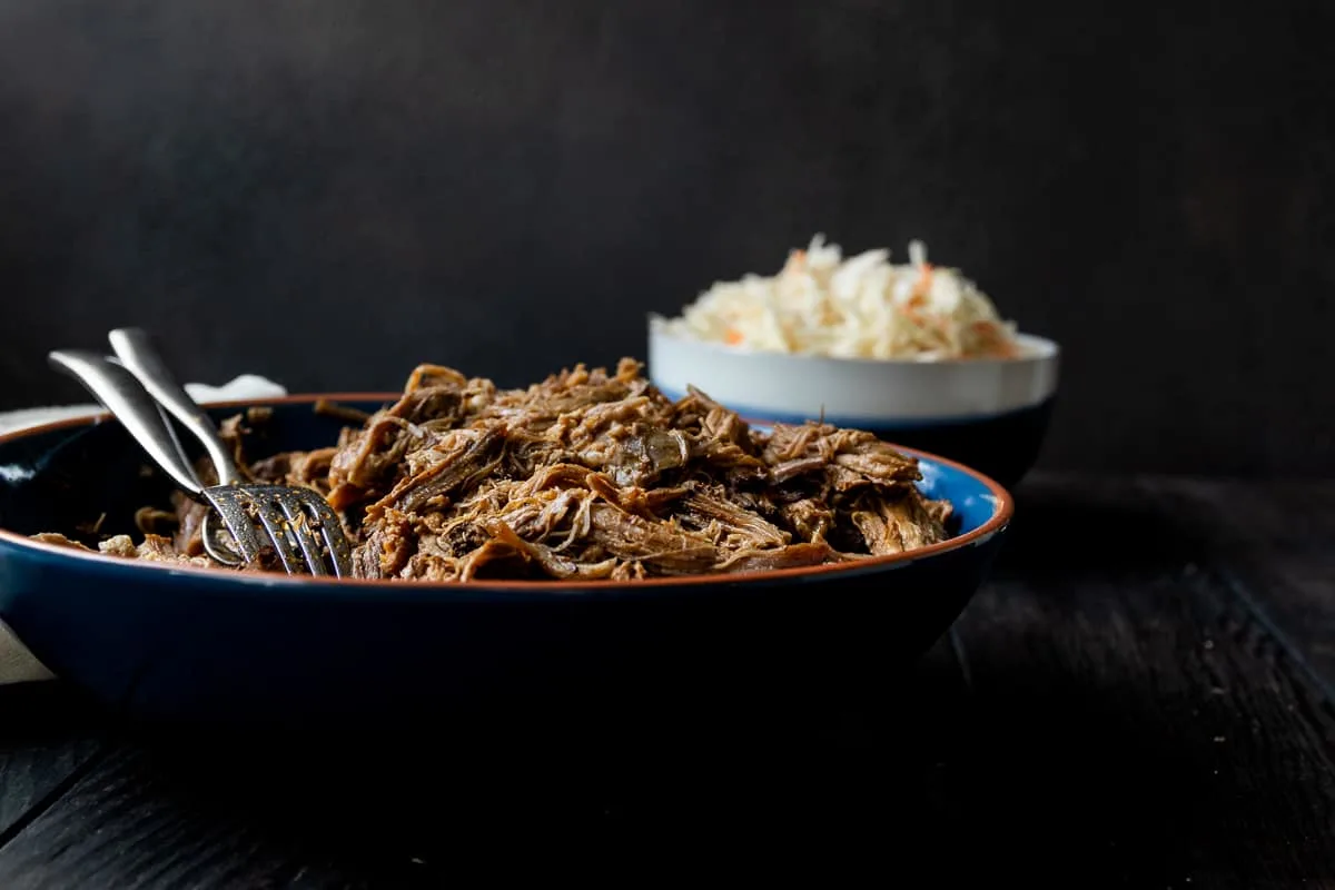 Low and slow is key for this easy slow cooker pulled pork recipe! You'll get smokehouse worthy results with this pulled pork recipe based off Georgia style pork barbecue! * Recipe on GoodieGodmother.com