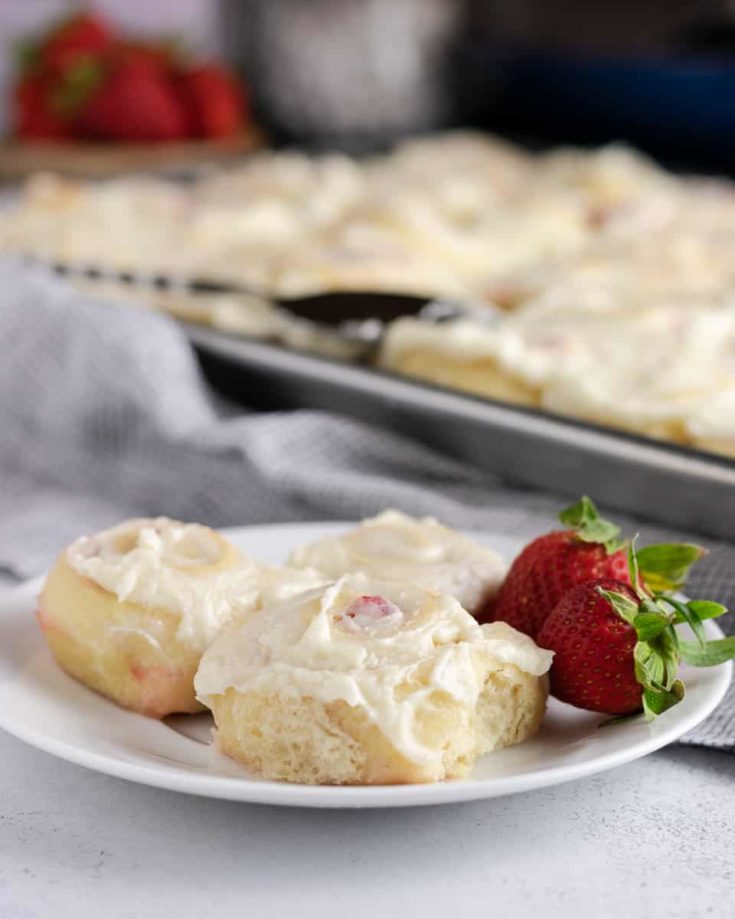 Sweet strawberry jam tucked into pillowy rolls and topped with cream cheese... in mini! You'll want to make these mini strawberry jam sweet rolls ASAP. * Recipe on GoodieGodmother.com