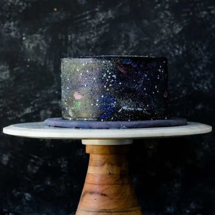 Decorate your own out of this world cake with this easy to follow buttercream galaxy cake decorating tutorial! Video and all the details on GoodieGodmother.com