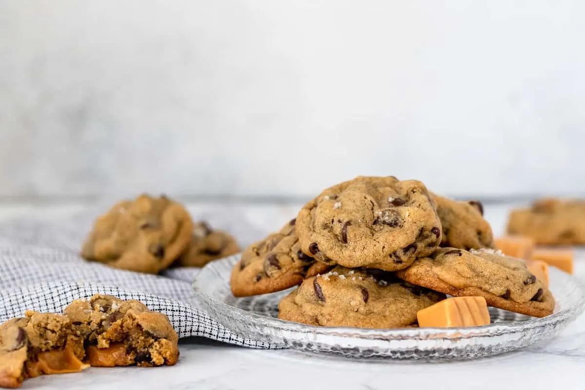 landscape picture of chocolate chip cookies on a plate with caramel