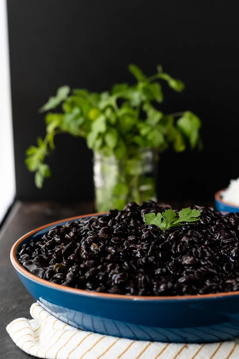 cuban black beans in a large bowl placed near a window
