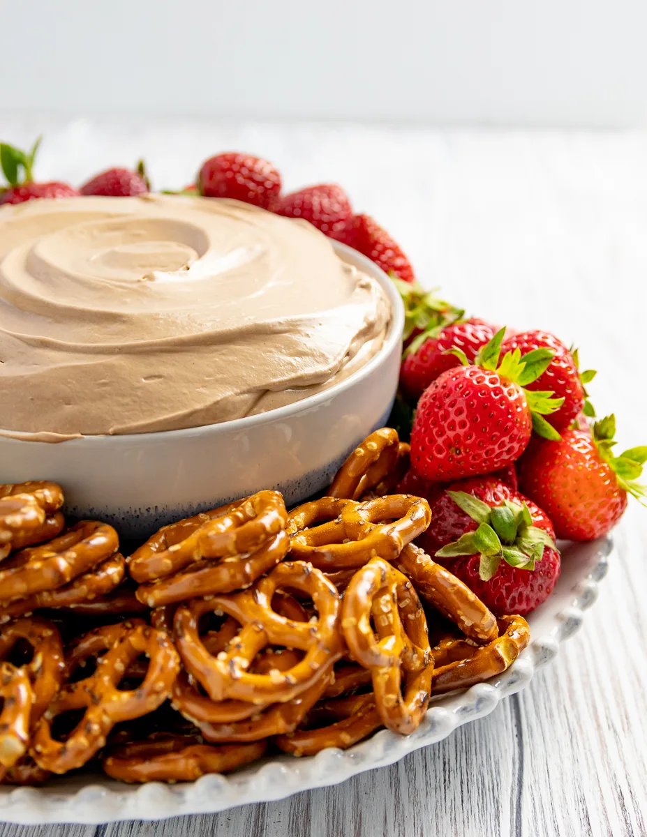 close up picture of Nutella fruit dip in a bowl with pretzels and strawberries