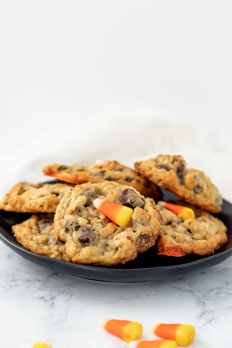 candy corn chocolate chip cookies on a black plate