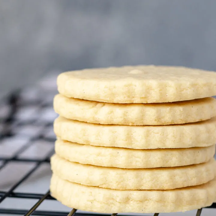 a stack of sugar cookies on a cooling rack