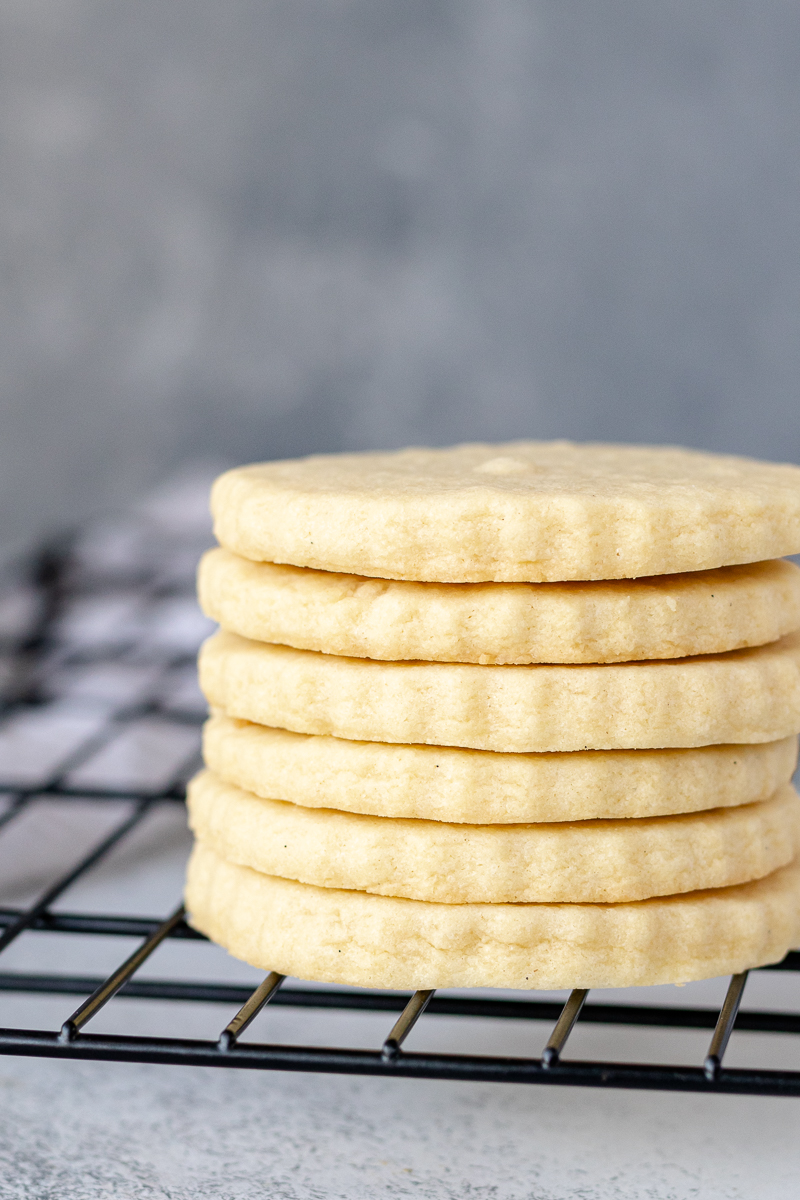 a stack of sugar cookies on a cooling rack