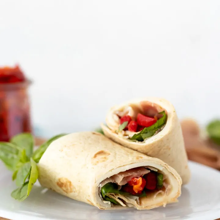 easy italian protein wrap on a white plate with a white background