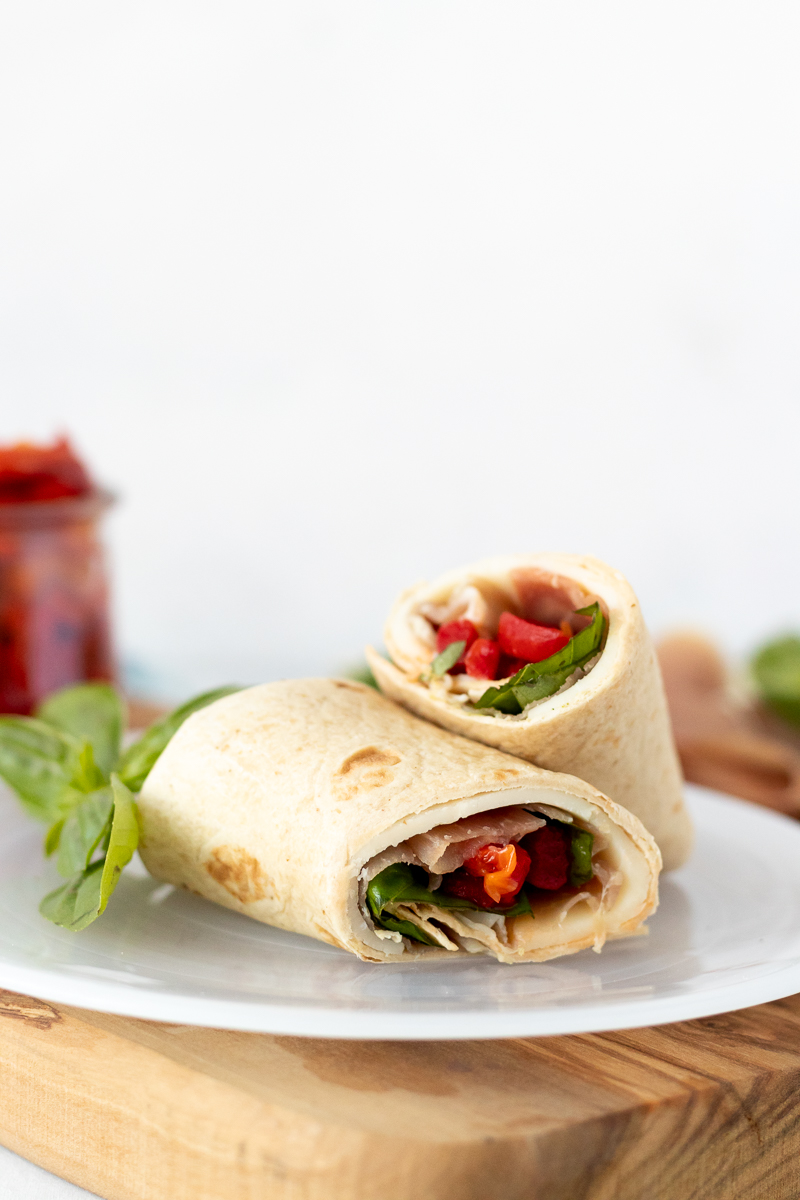 easy italian protein wrap on a white plate with a white background