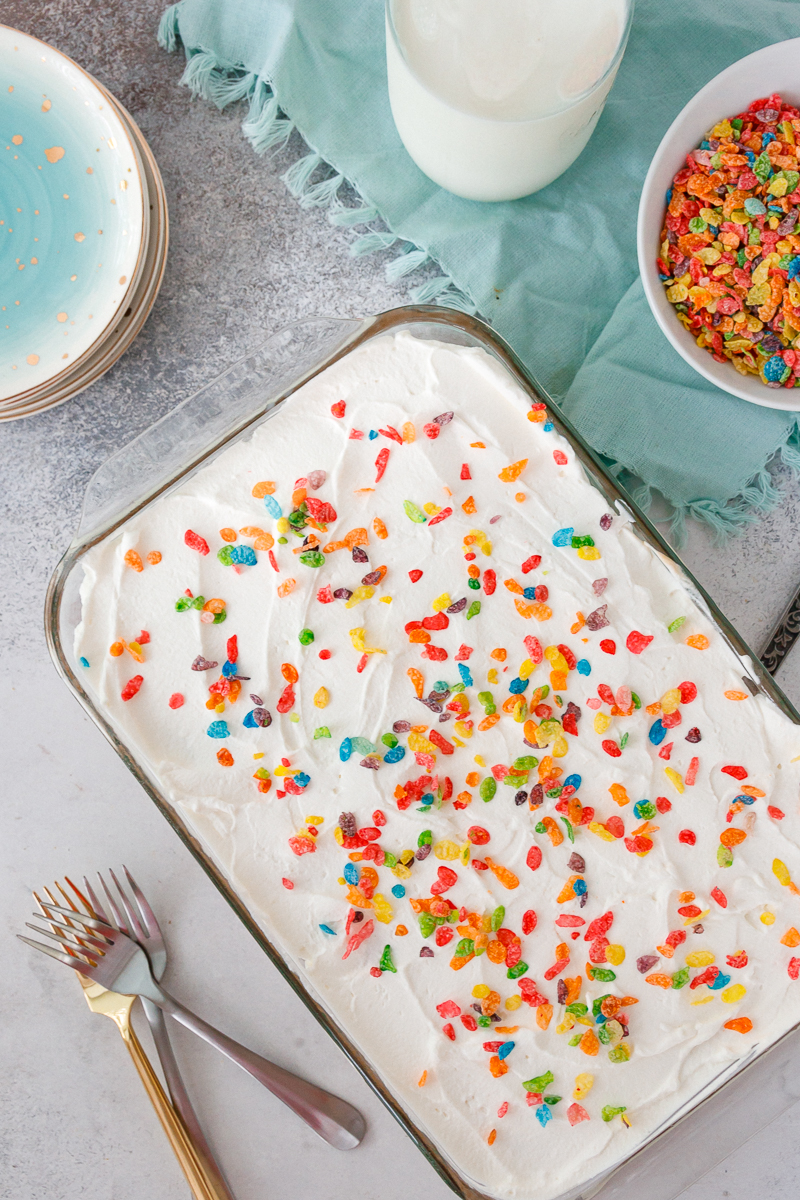 top view of a fruity pebbles cereal milk poke cake